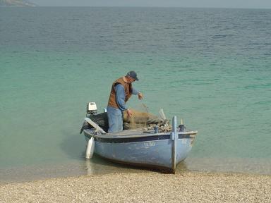 A fisherman works on Brac Island